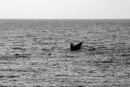 Solitary canoe at sea